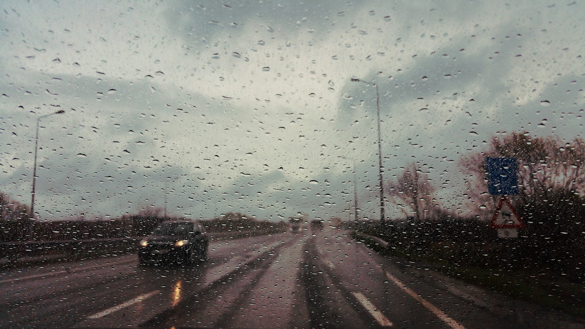 rainy road through car windscreen