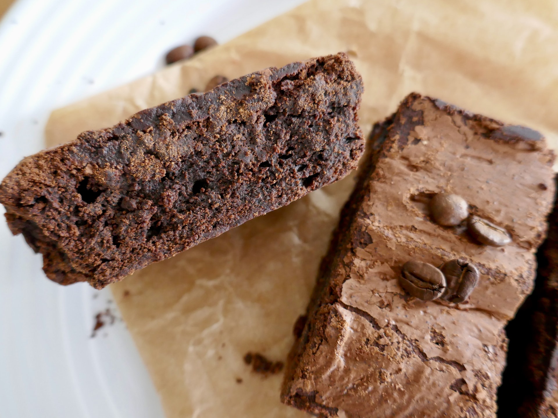 2 slices of chocolate brownie on wooden board