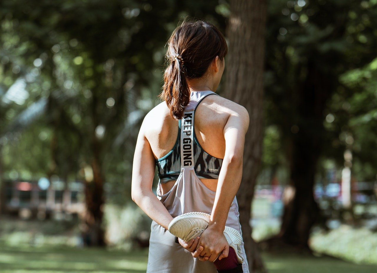 Asian woman stretching in park