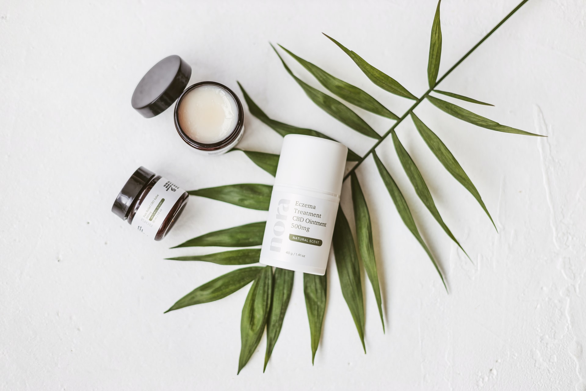 CBD beauty products on top of leaf