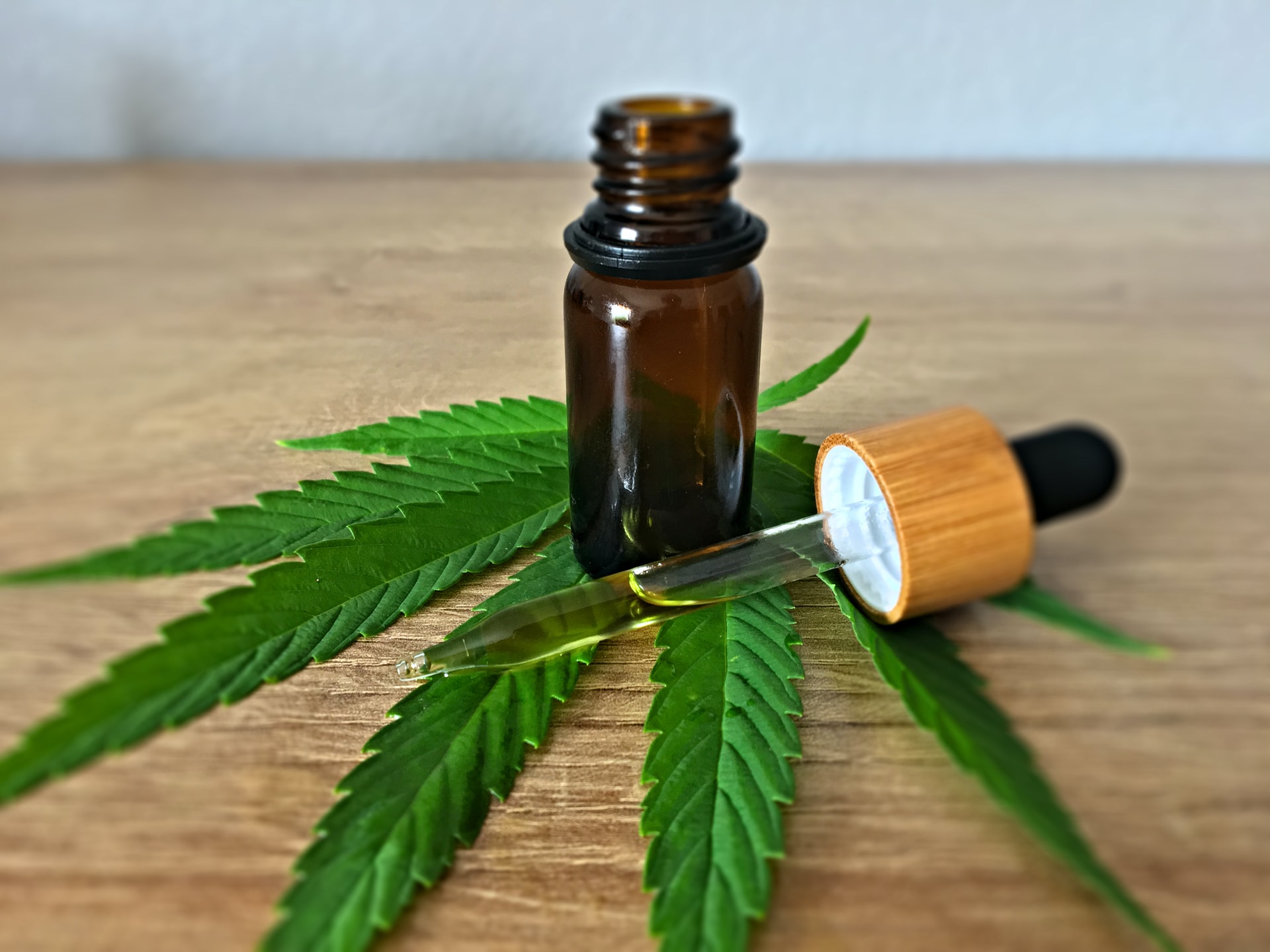 CBD oil bottle on cannabis leaf