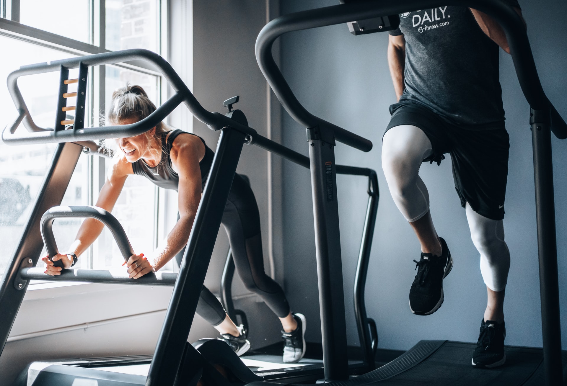 male and female on gym equipment