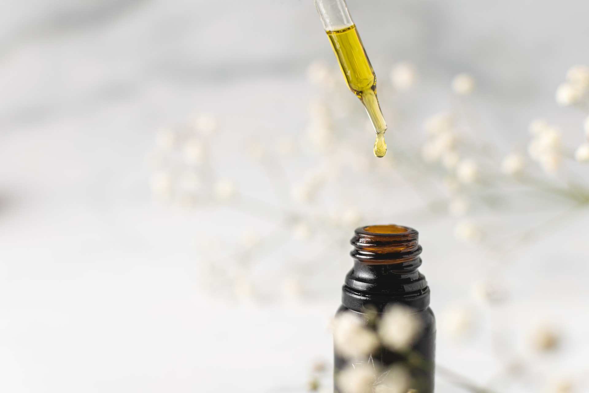 oil being dopped into small bottle